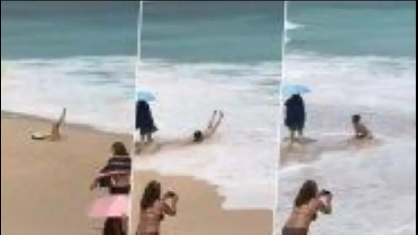 समंदर किनारे लेट रही थी महिला, अचानक आई तेज लहर और फिर जो हुआ  Watch Viral Video