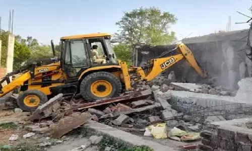 Bulldozer rammed into house of accused in Kaushambi triple murder case Bulldozer rammed into house of accused in Kaushambi triple murder case